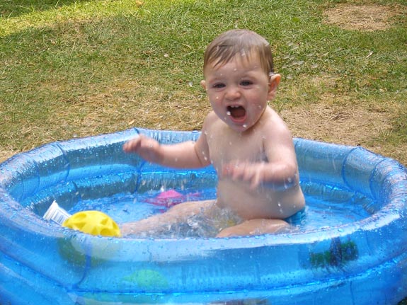 [Having fun in his paddling pool]
