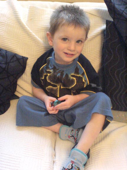 [Dressed in his Batman PJs]