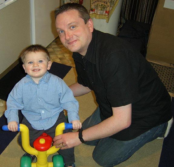 [Tom playing on his tricycle with Daddy]
