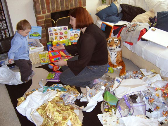 [Mummy helps Tom unwrap his many, many presents]